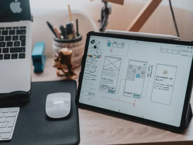 UI/UX design process with wireframes, user interface elements, and creative design tools.